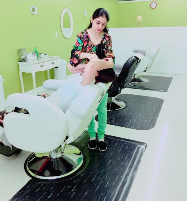 woman doing eyebrow threading in salon